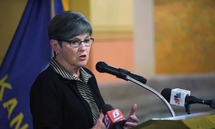 Kansas Governor to Sign Bill That Makes Businesses Allow Broad Exemptions to COVID-19 Vaccine Requirements